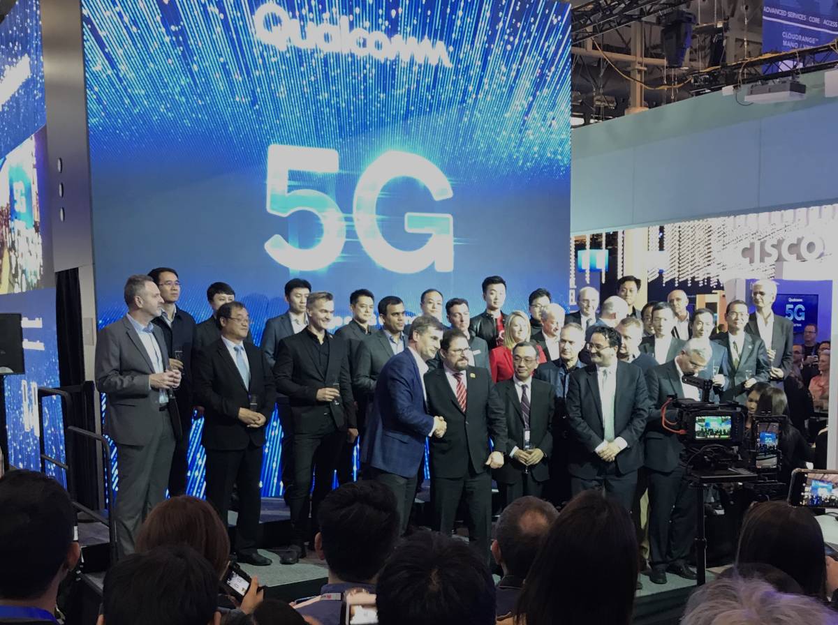 Qualcomm president Cristiano Amon greets Verizon Wireless president Ronan Dunne at the Mobile World Congress conference in Barcelona.