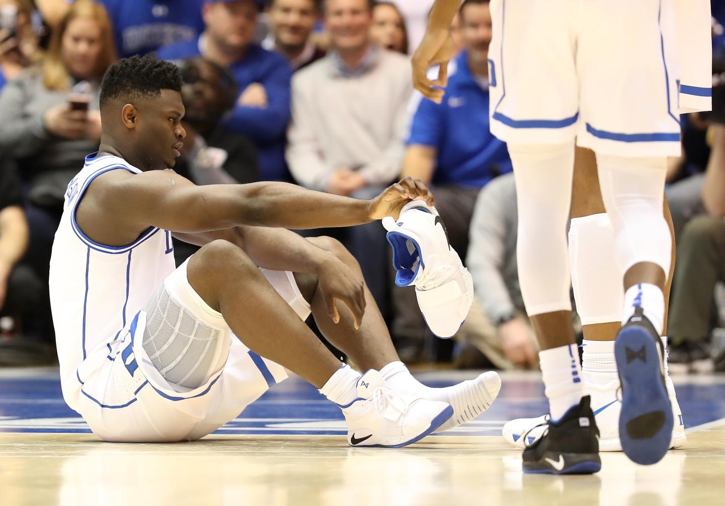 Duke's Zion Williamson reacts after his shoe breaks during a game on Feb. 20, 2019, in Durham, N.C.