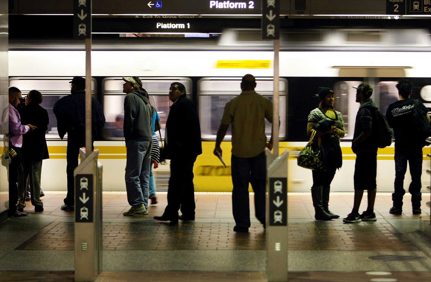 Morning commuters stand past the stand-alone TAP (Transit Access Pass) validators at the transfer p