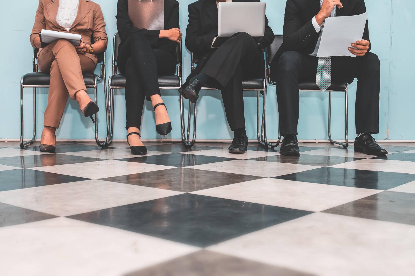 Low Section Of People Waiting For Interview On Chair