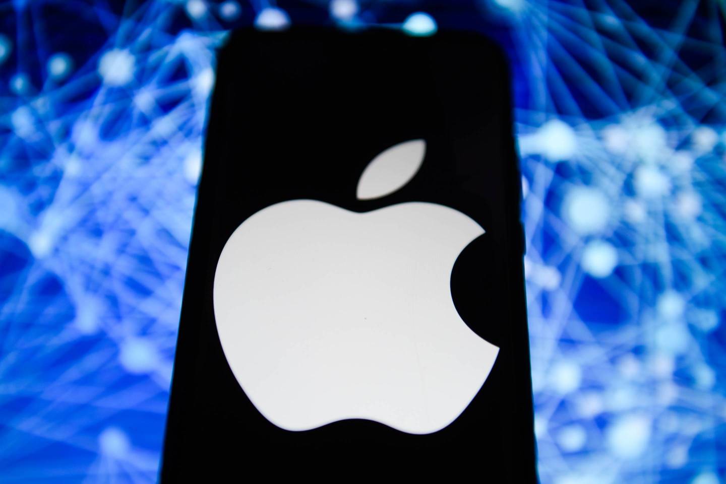 Apple logo is seen on a mobile phone