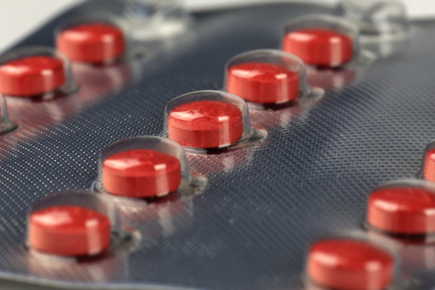 Red colored medical pills in a blister pack