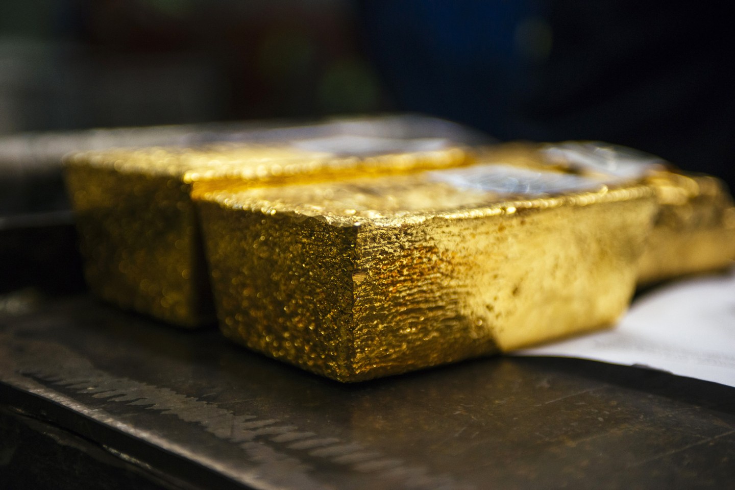 Gold bullion bars sit following casting at a refinery