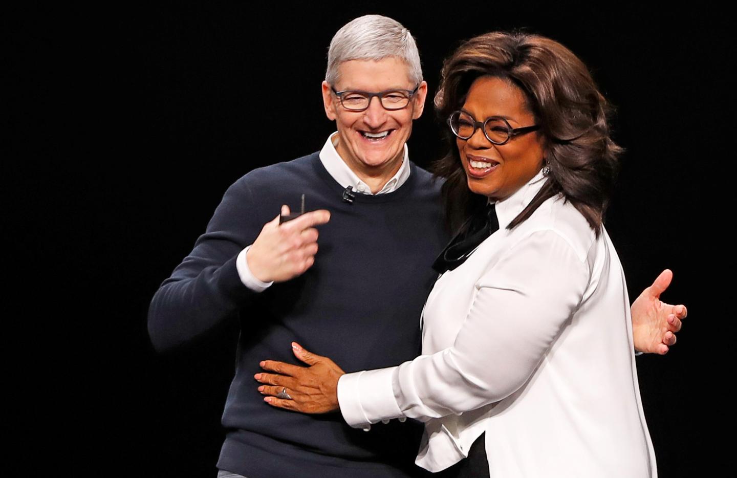Tim Cook, CEO of Apple and Oprah Winfrey hug during an Apple special event at the Steve Jobs Theater in Cupertino
