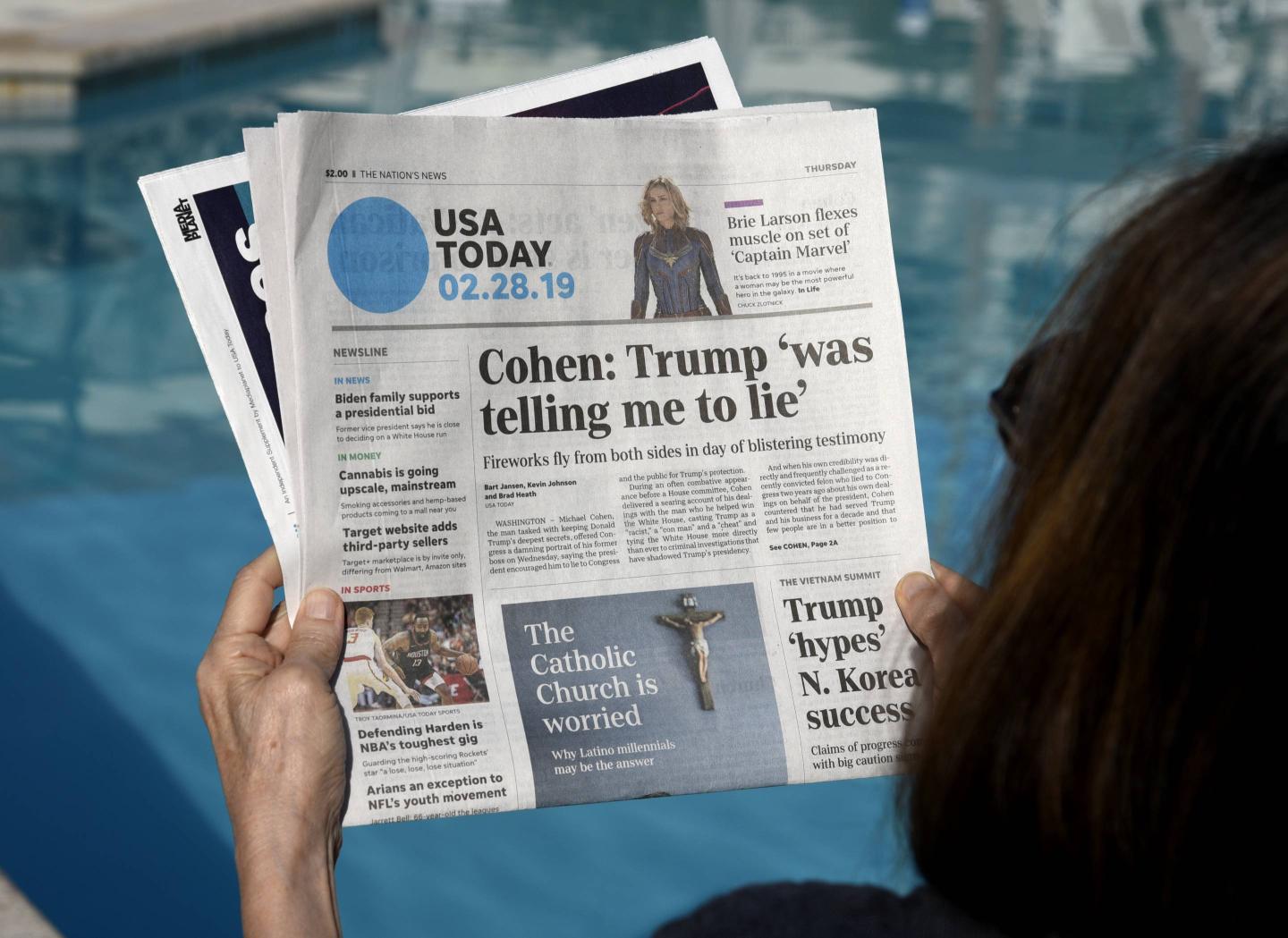 woman reading USA Today newspaper