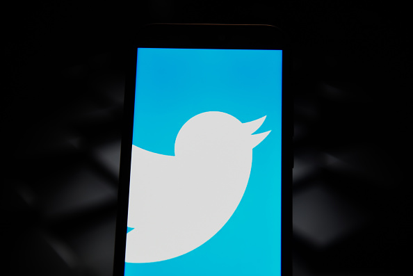 In this photo illustration a Twitter logo seen displayed on