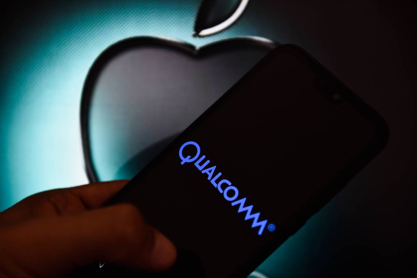 In this photo illustration a Qualcomm logo seen displayed on