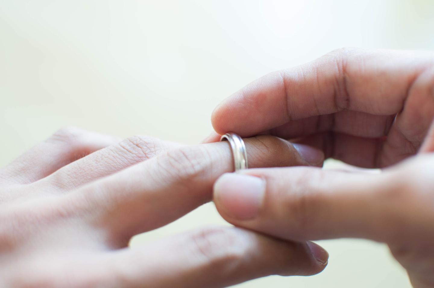 A man is holding his wedding ring