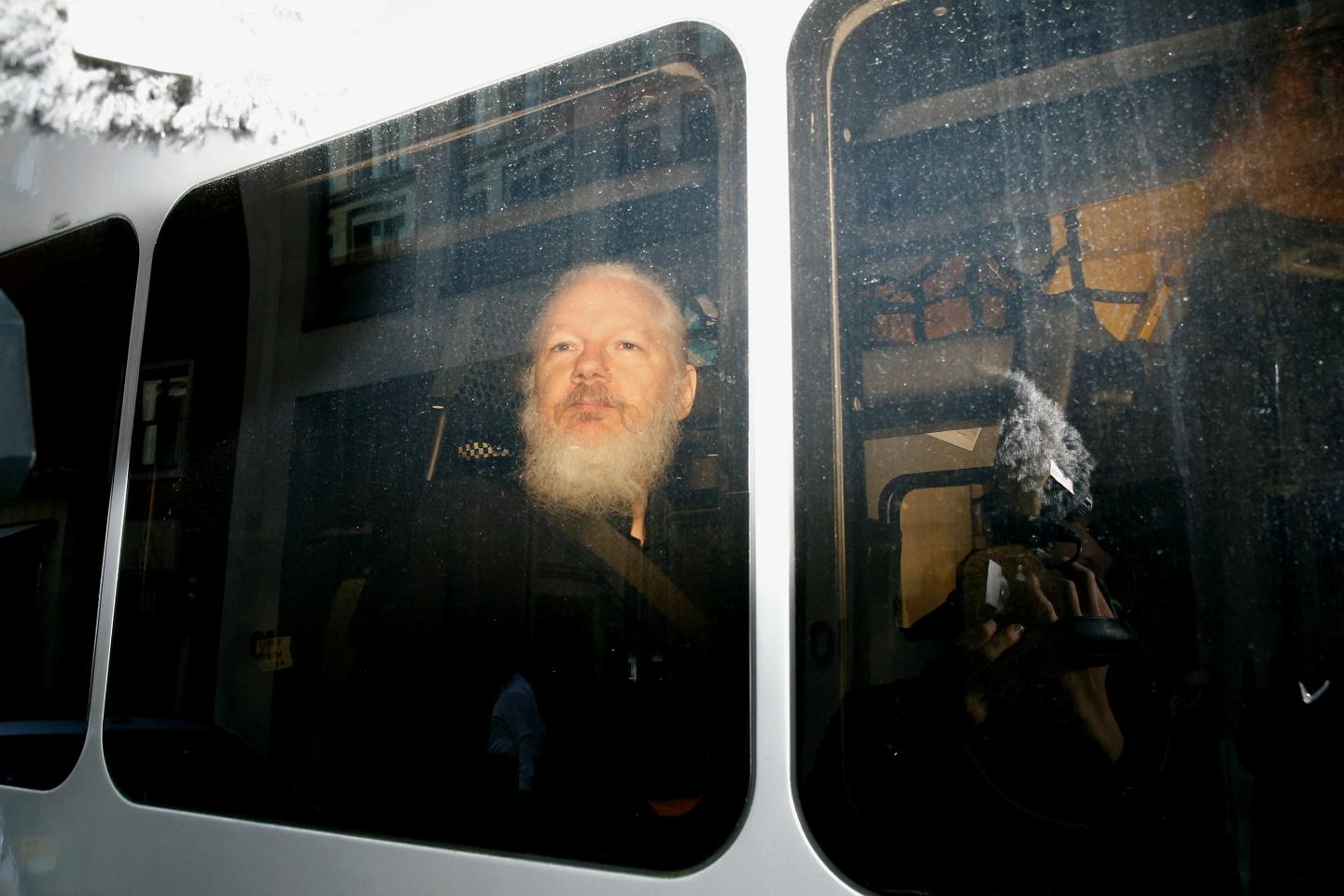 WikiLeaks founder Julian Assange is seen in a police van, after he was arrested by British police, in London