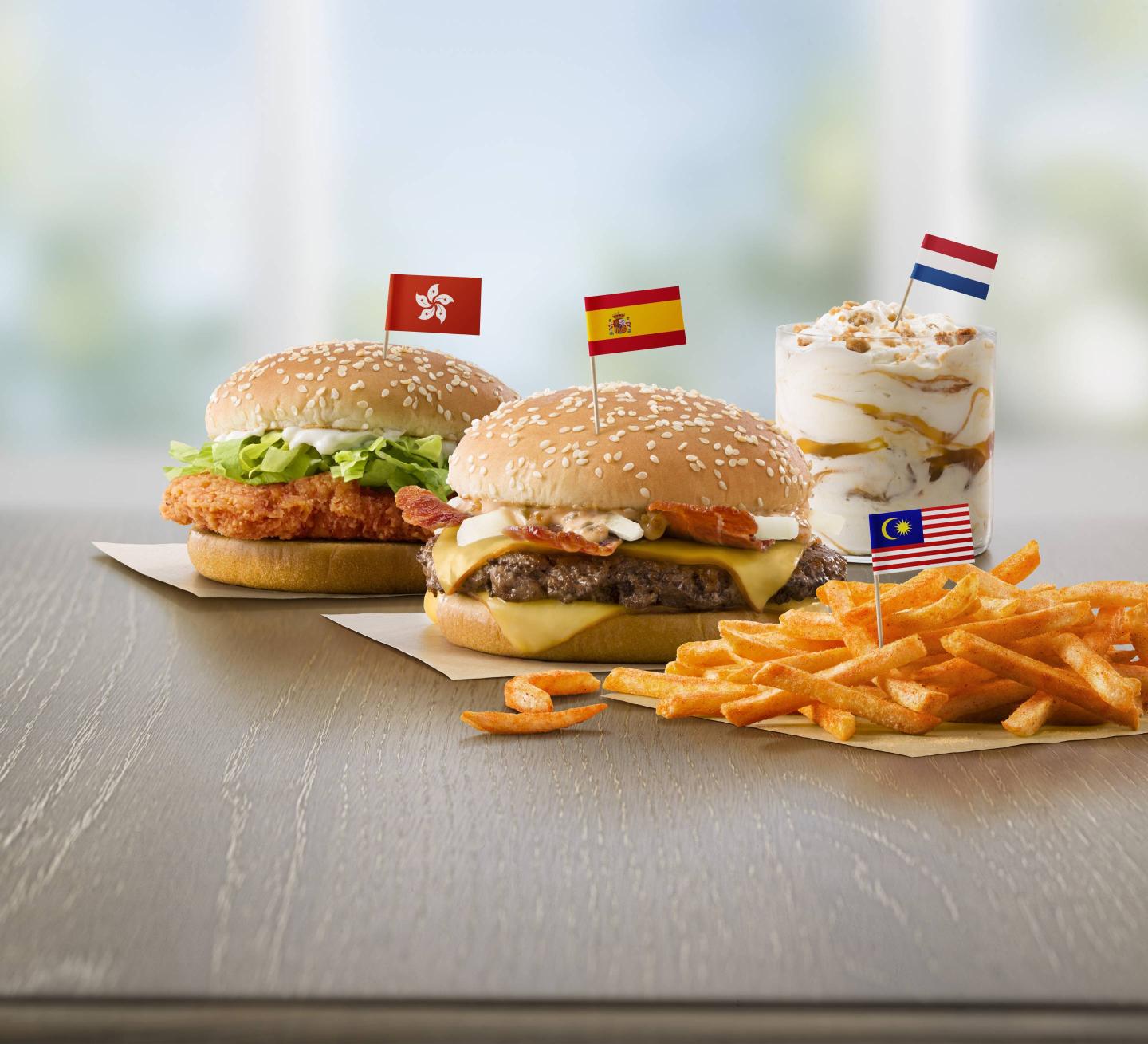Flavors from Abroad / Taste of the World (left to right): Hong Kong's McSpicy Chicken Sandwich, Spain's Grand McExtreme Bacon Burger, Malaysia's BBQ McShaker Fries and Netherlands' Stroopwafel McFlurry.  Drive Thru Translite.