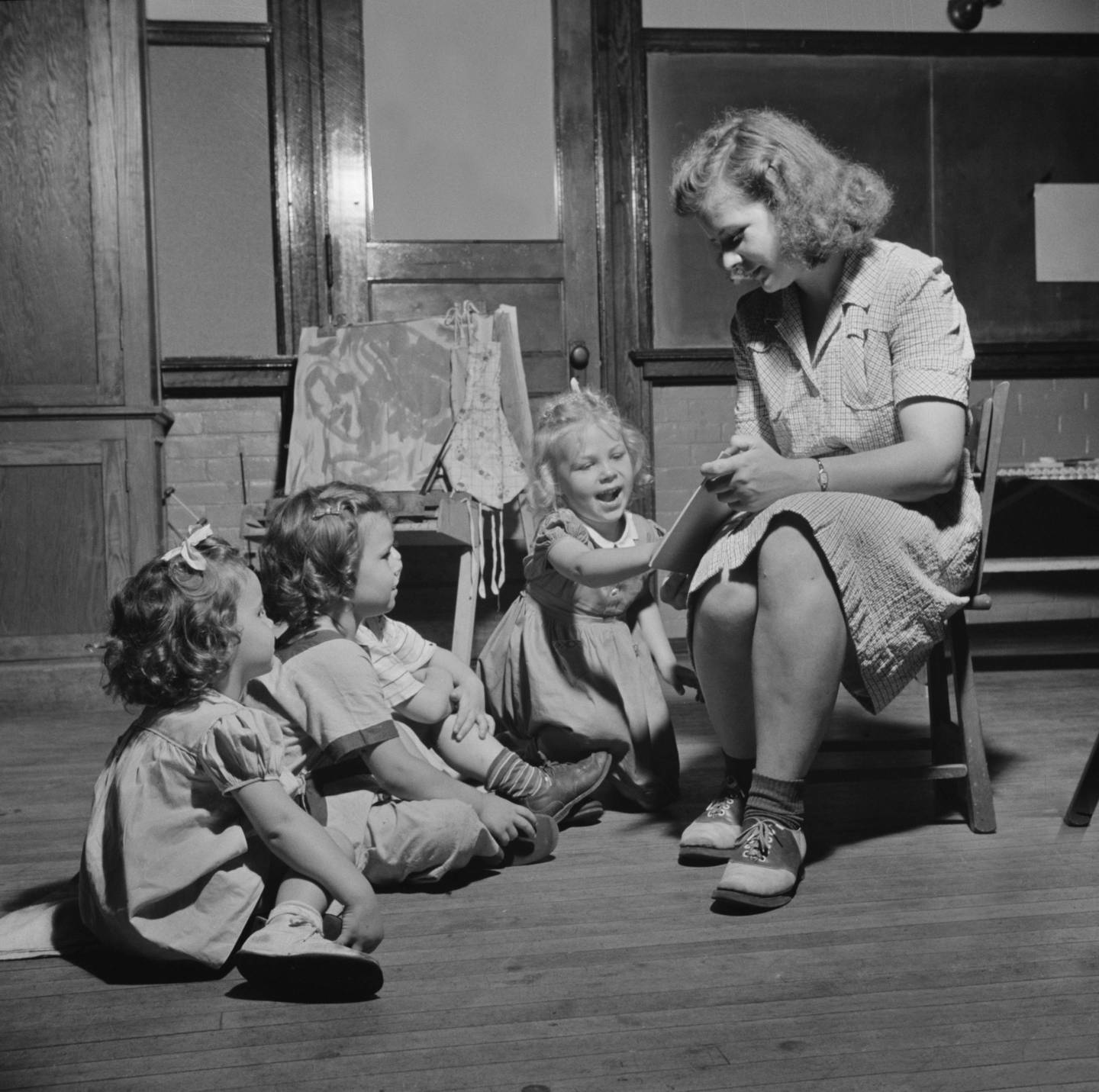 Woman Reading Story to Three Young Children at Child Care Center, New Britain, Connecticut, June 1943