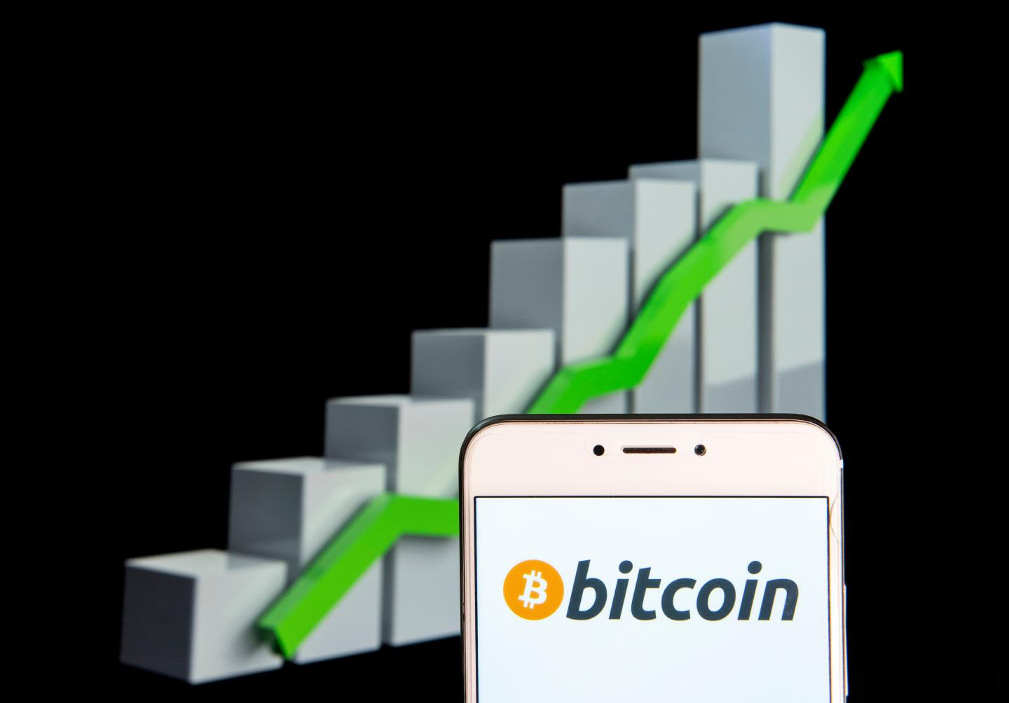 Cryptocurrency electronic cash Bitcoin logo is seen on a phone