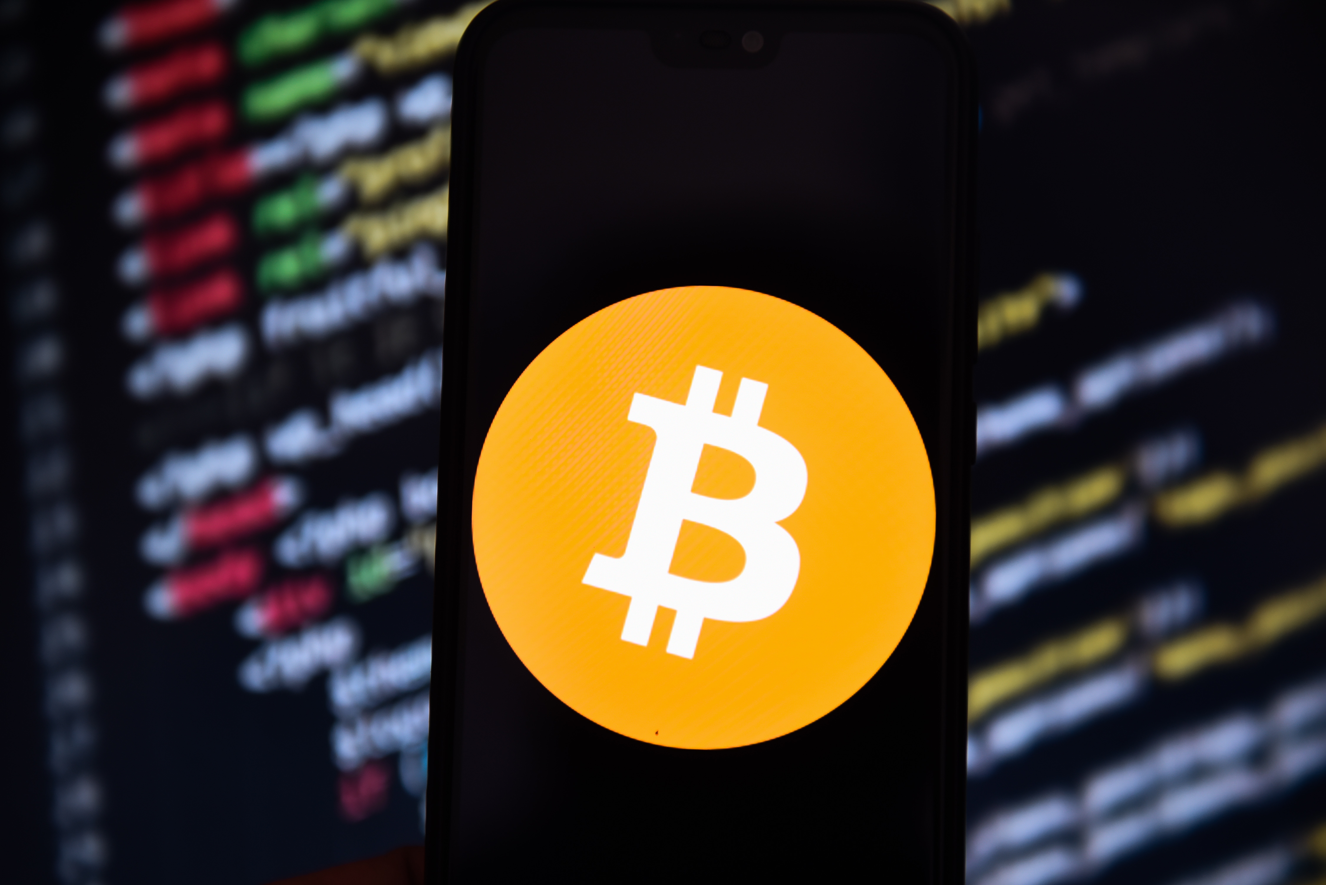 In this photo illustration a Bitcoin logo seen displayed on