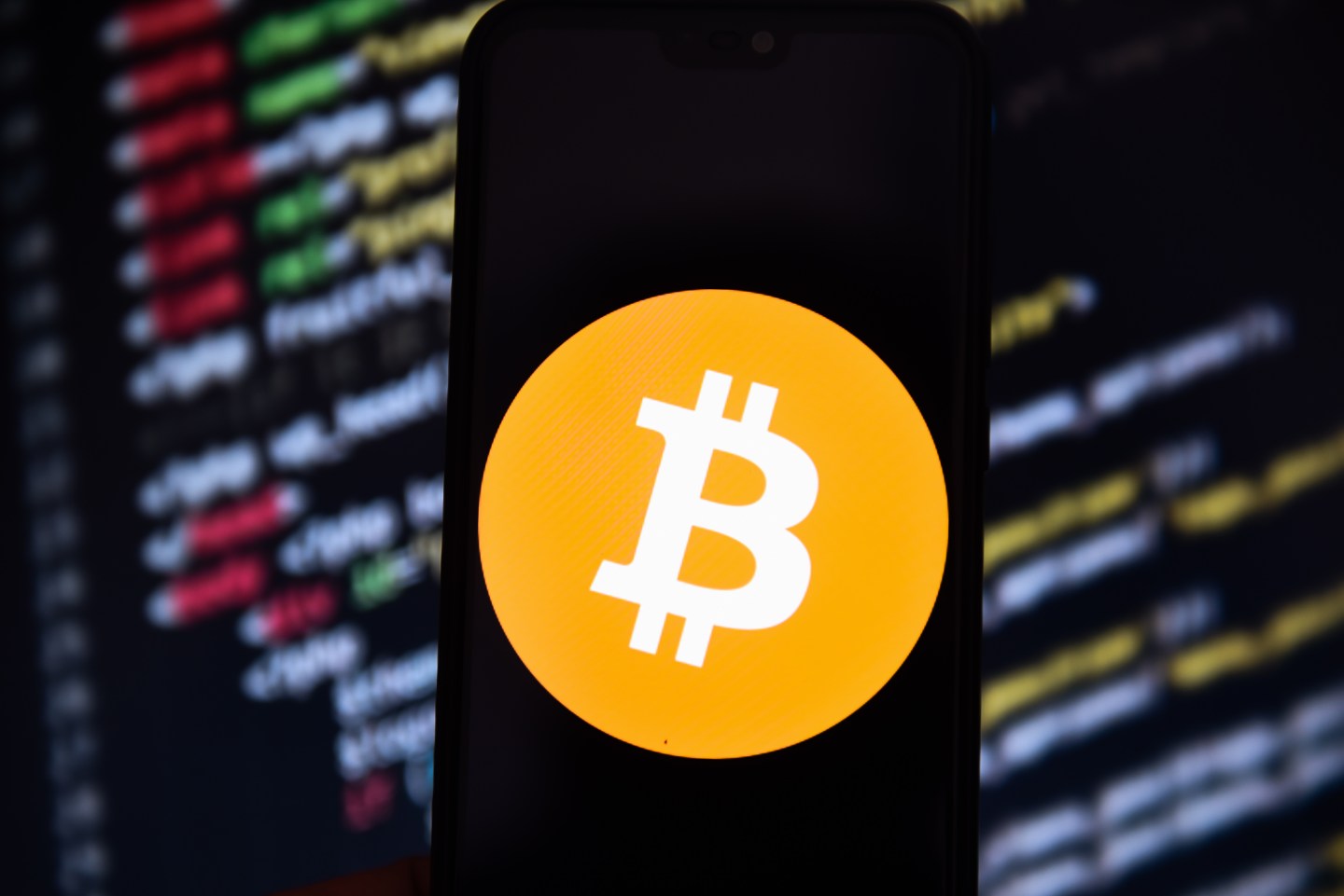 In this photo illustration a Bitcoin logo seen displayed on