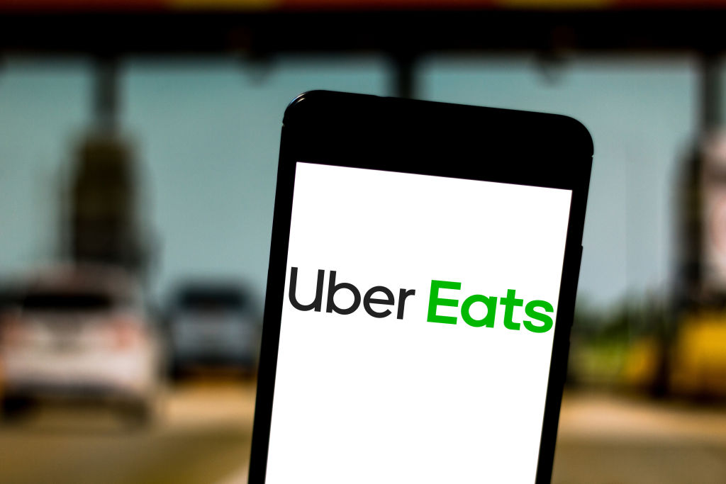 In this photo illustration the Uber Eats logo is seen