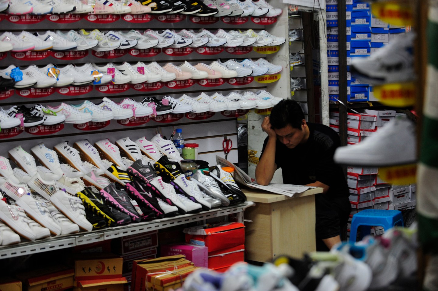 A shoe vendor waits for customers at his store in Hefei, Anhui province