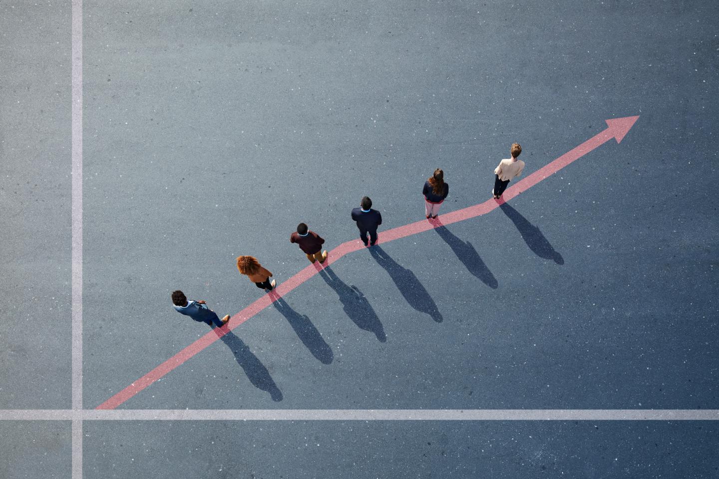 Businesspeople standing on painted up going graph on asphalt