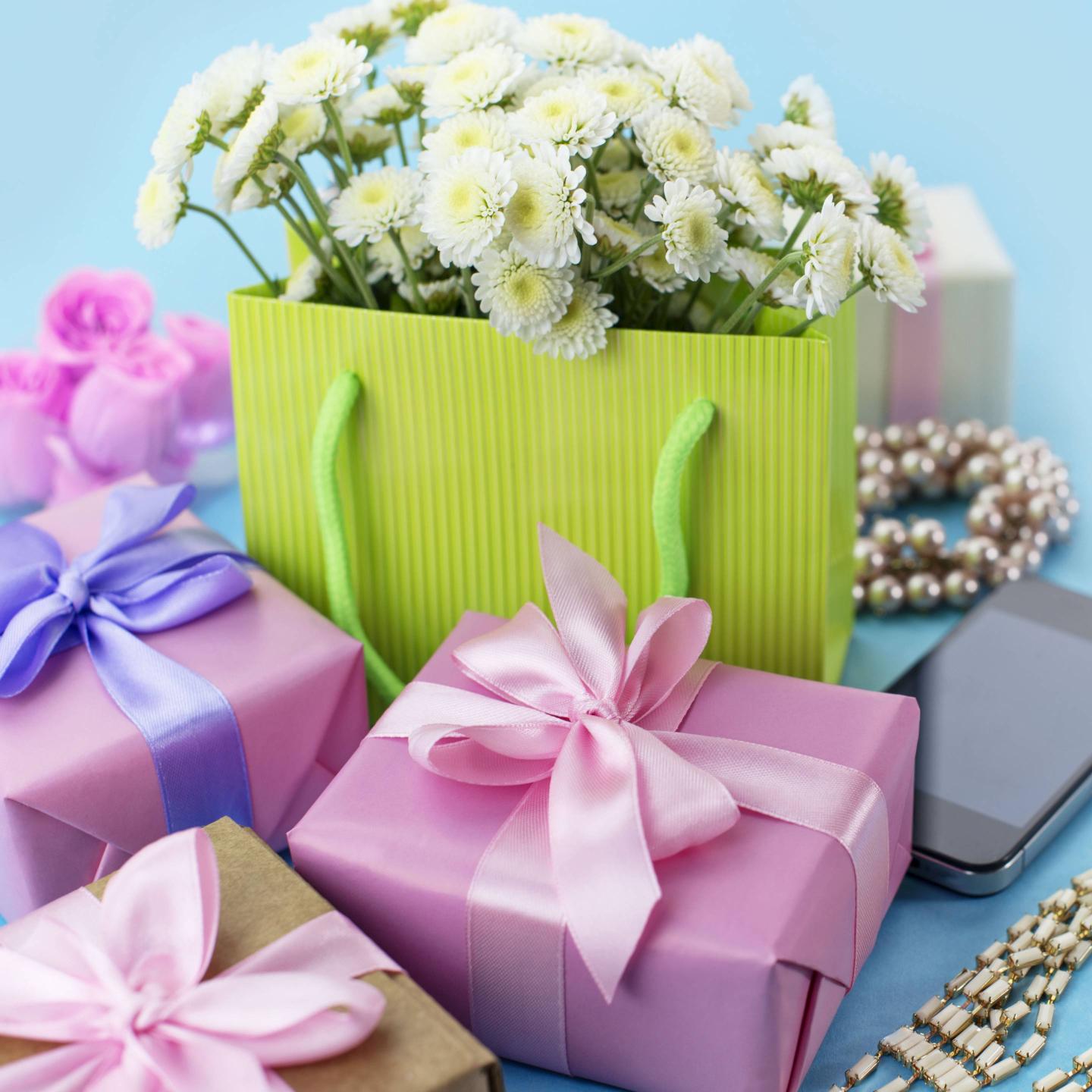 Decorative composition boxes with gifts flowers women's jewelry shopping holiday blue background.