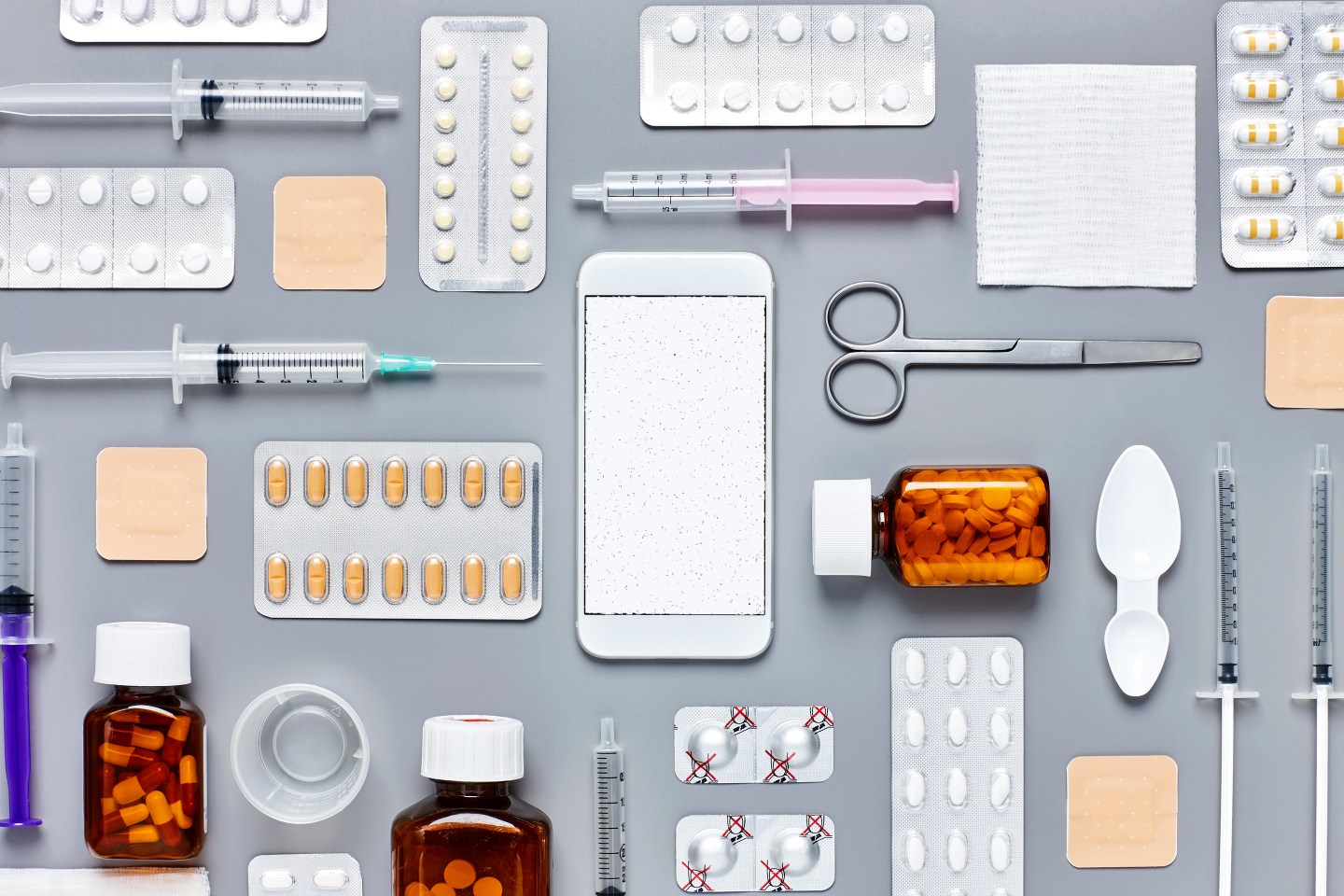 Knolling concept of smart phonePhone Health Supplies Recordssurrounded with medicines and sy