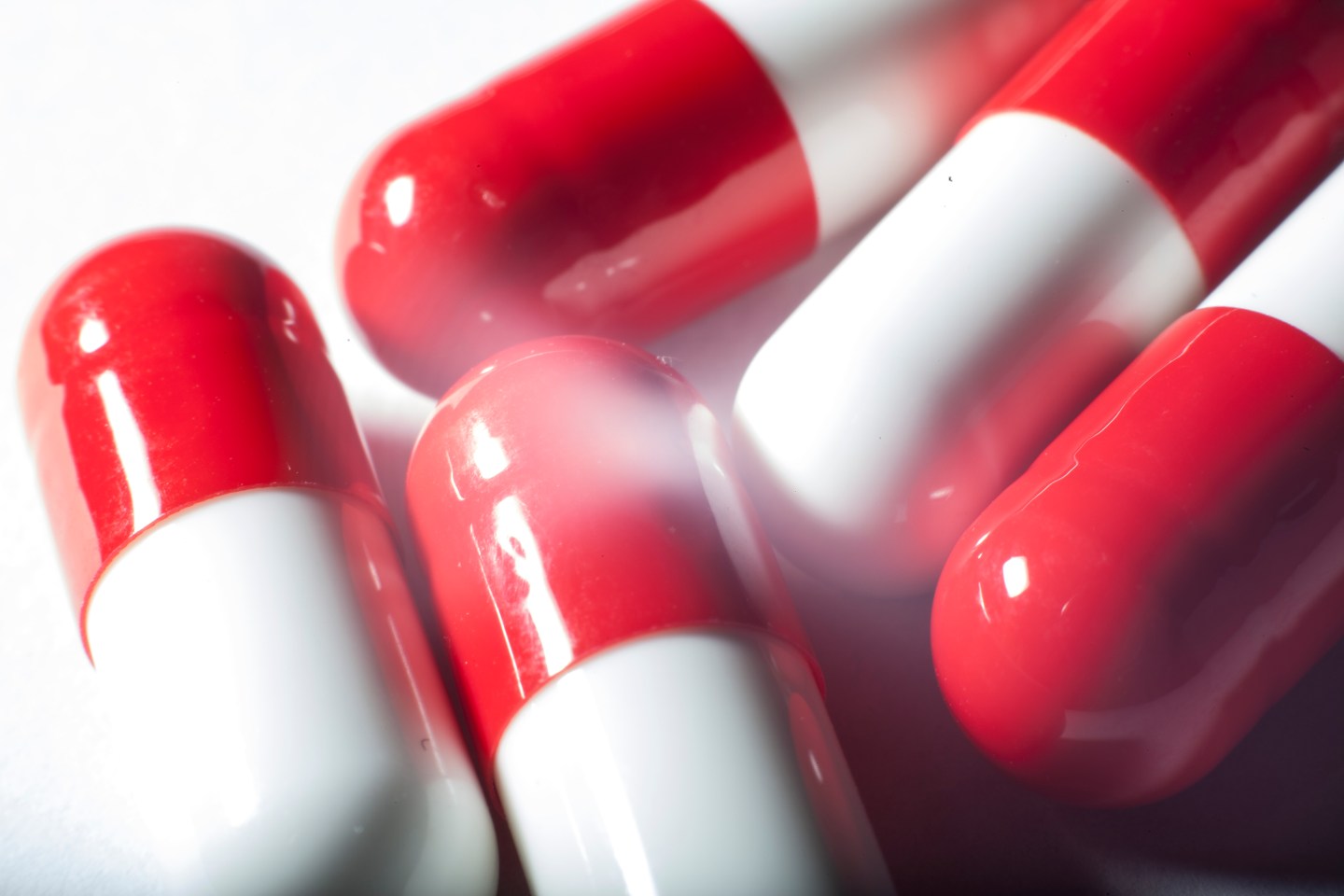 Red and white pills on a table