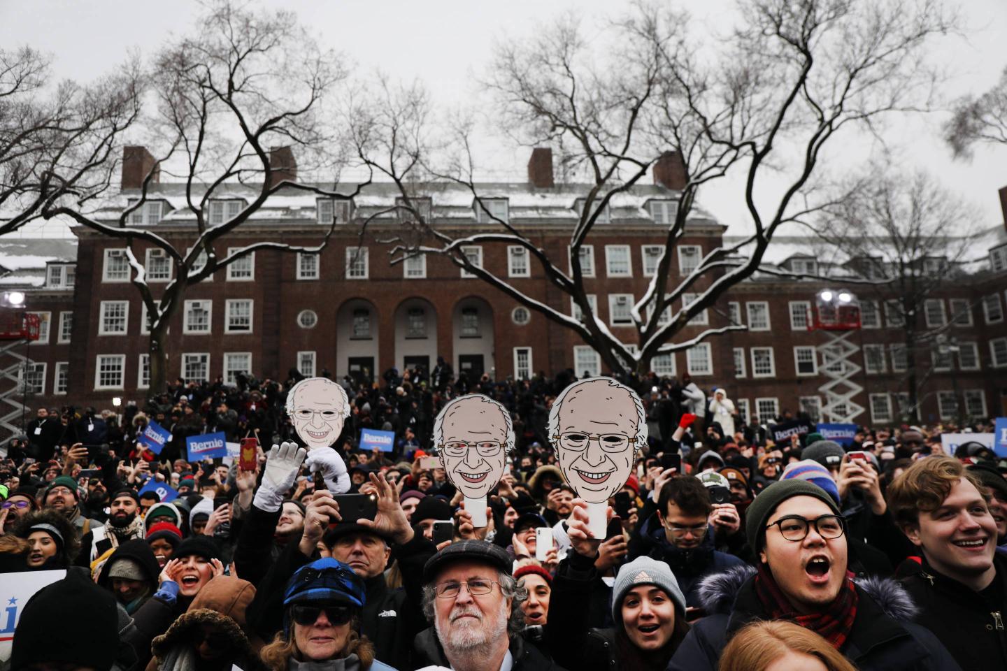 People listen to presidential candidate, and self-described democratic socialist, Sen. Bernie Sanders (I-VT) at a rally in Brooklyn.