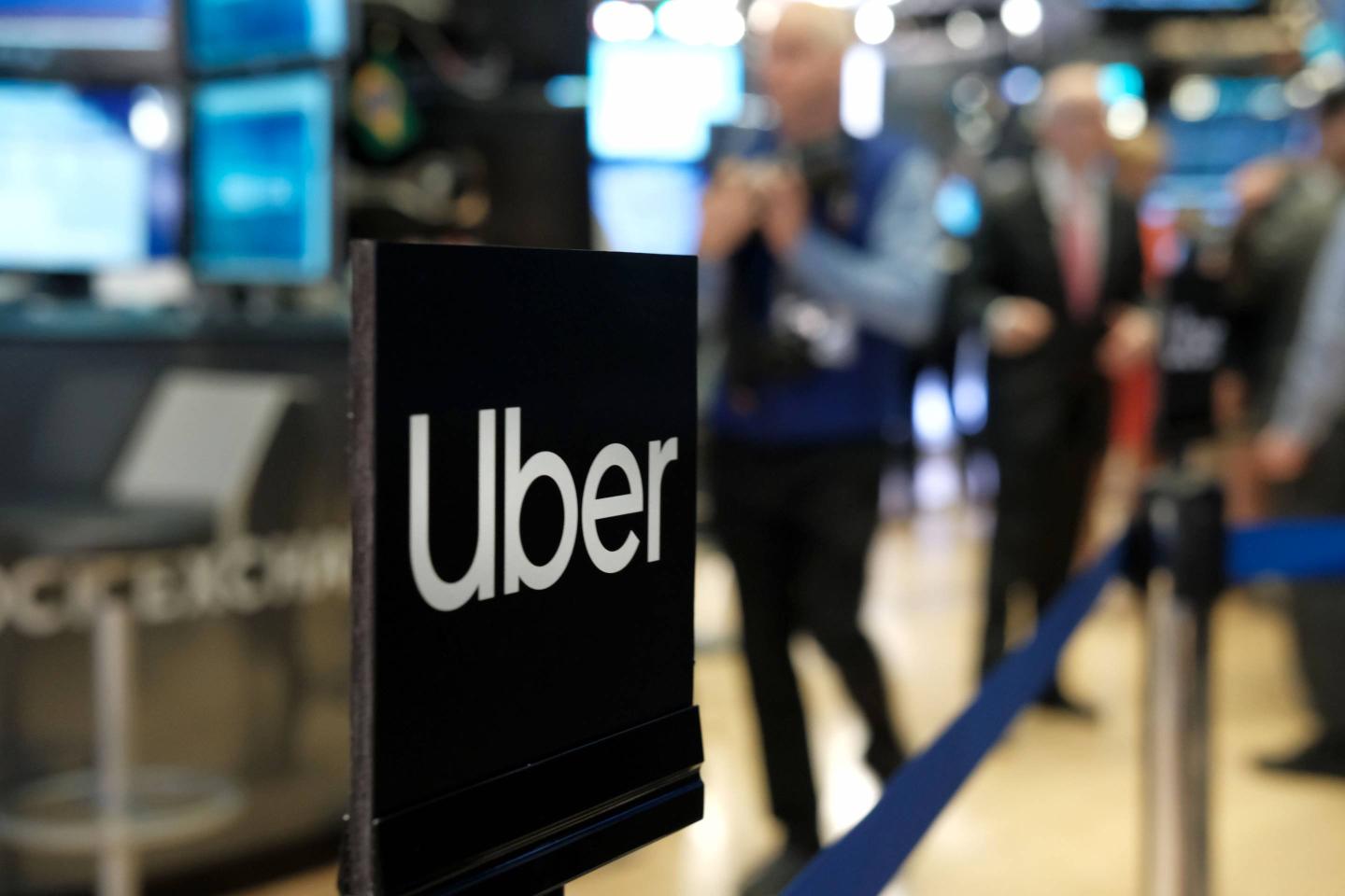 An Uber sign is displayed on the floor of the New York Stock Exchange (NYSE) as the ride-hailing company makes its highly anticipated IPO on May 10, 2019.