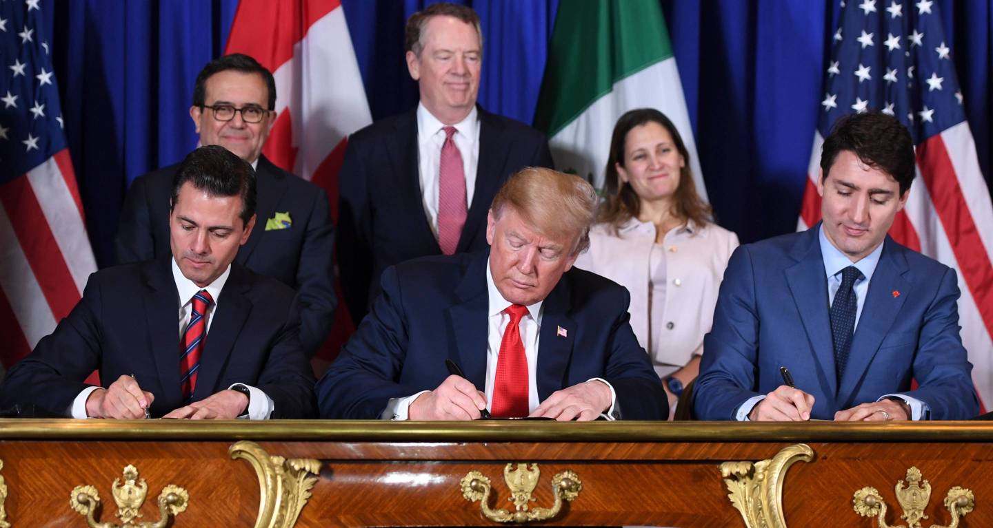 Mexico's President Enrique Pena Nieto (L), U.S. President Donald Trump (C), and Canadian Prime Minister Justin Trudeau sign the US-Mexico-Canada Agreement (USMCA)