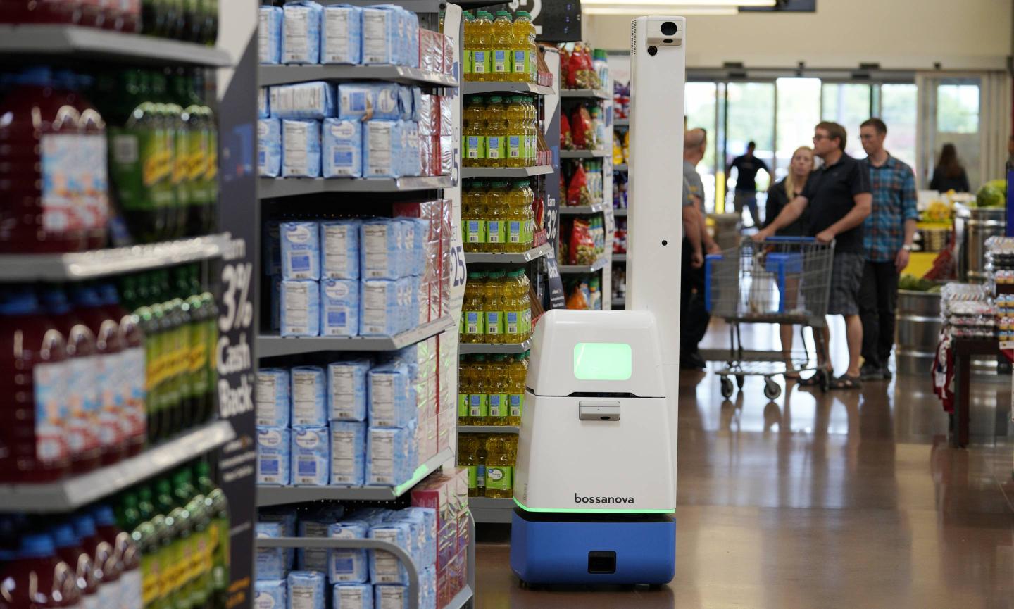 A Bossa Nova Robotics scanning device moves through an aisle at a Walmart Supercenter during the company's annual shareholders meeting on May 31, 2018 in Rogers, Ark.