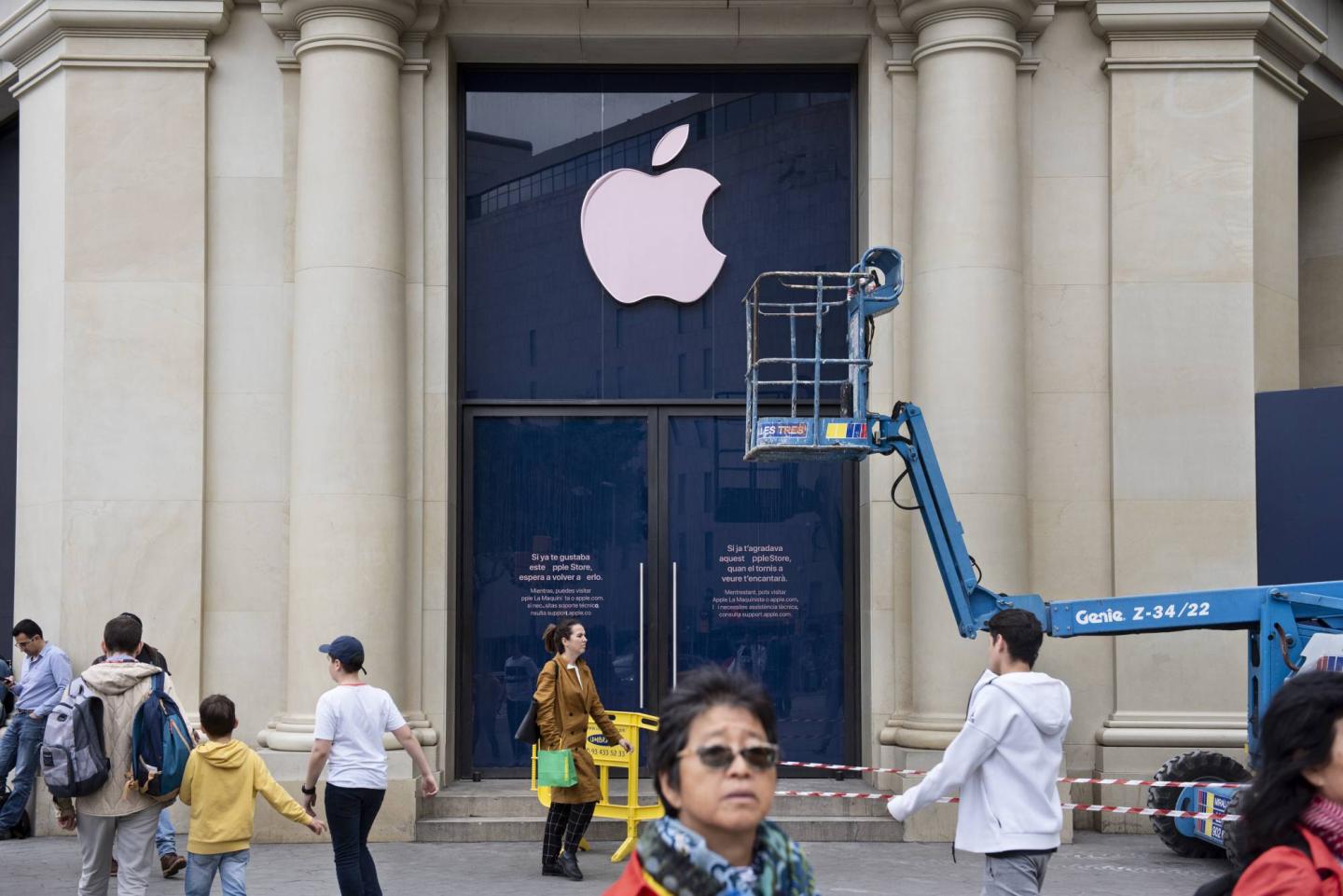 Pedestrians walks past an American multinational technology