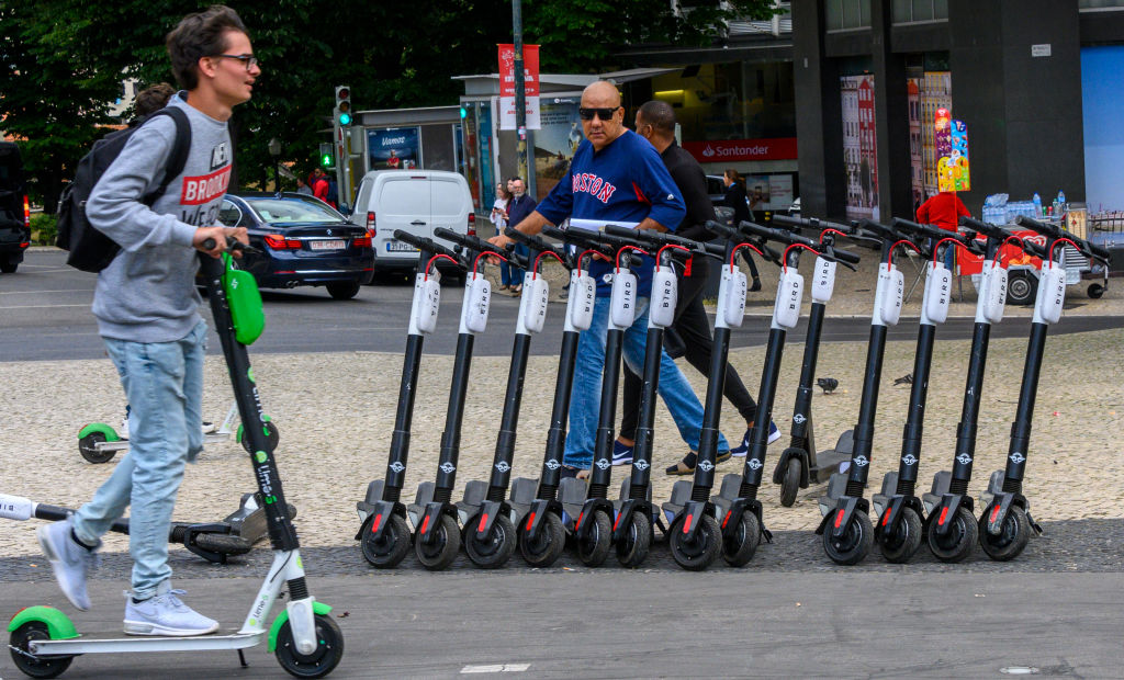 Tourists and locals ride e-scooters in Lisbon