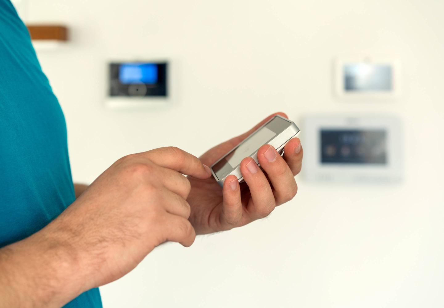 Man using digital device high tech touch screen for smart home functions