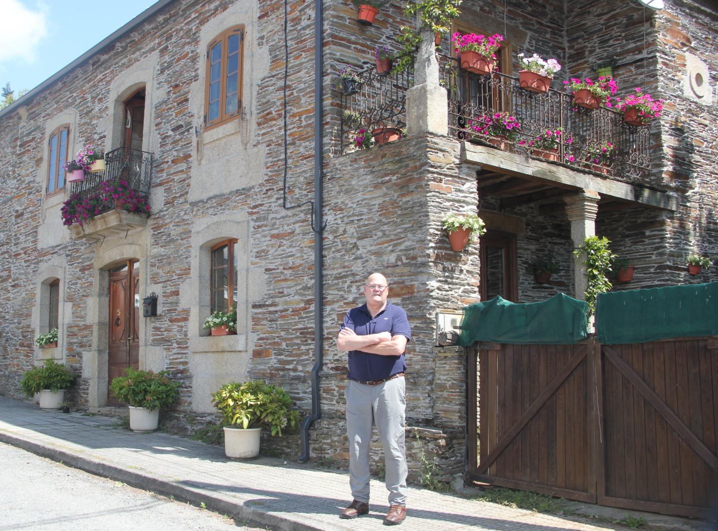 Mark Adkinson outside his renovated home in Lugo, Spain