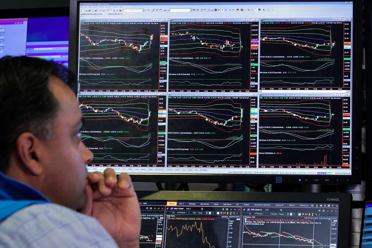 Traders work on the floor at the NYSE in New York