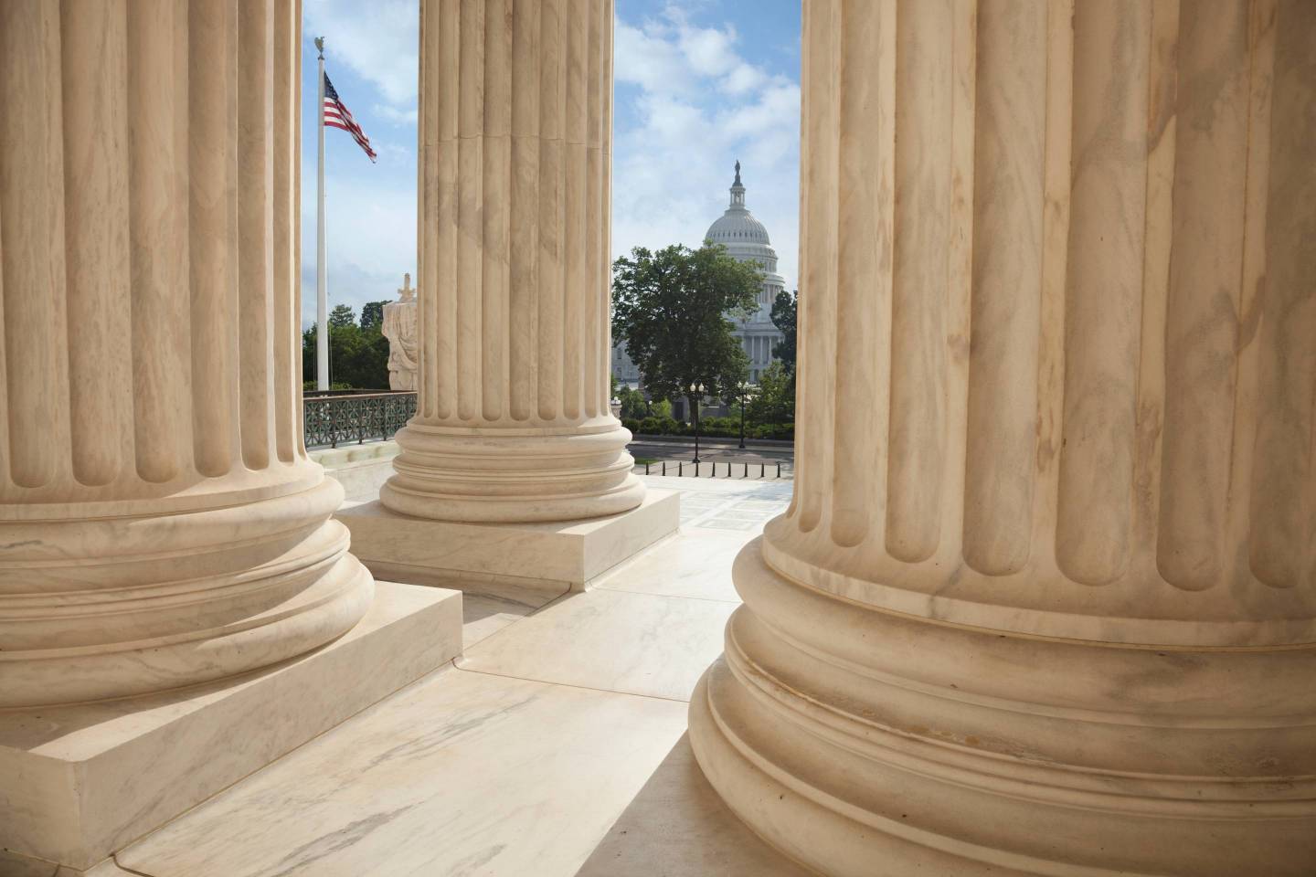 Capitol Building Seen Through Columns Of Us Supreme Court Building