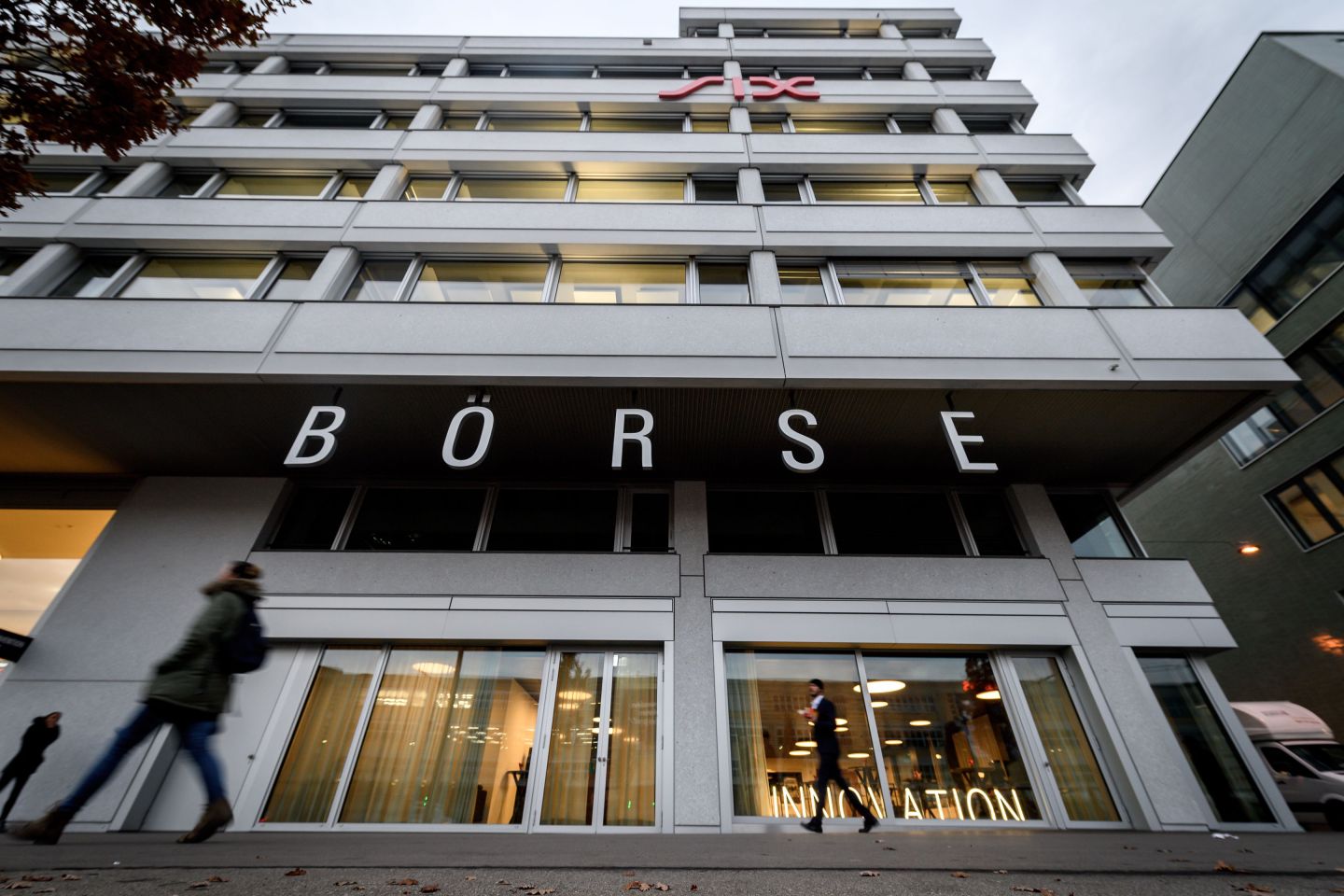 People walk in front of the headquarters of the Swiss Stock Exchange (Boerse) operated by the SIX group in Zurich on November 29, 2018. (Photo credit FABRICE COFFRINI/AFP/Getty Images)