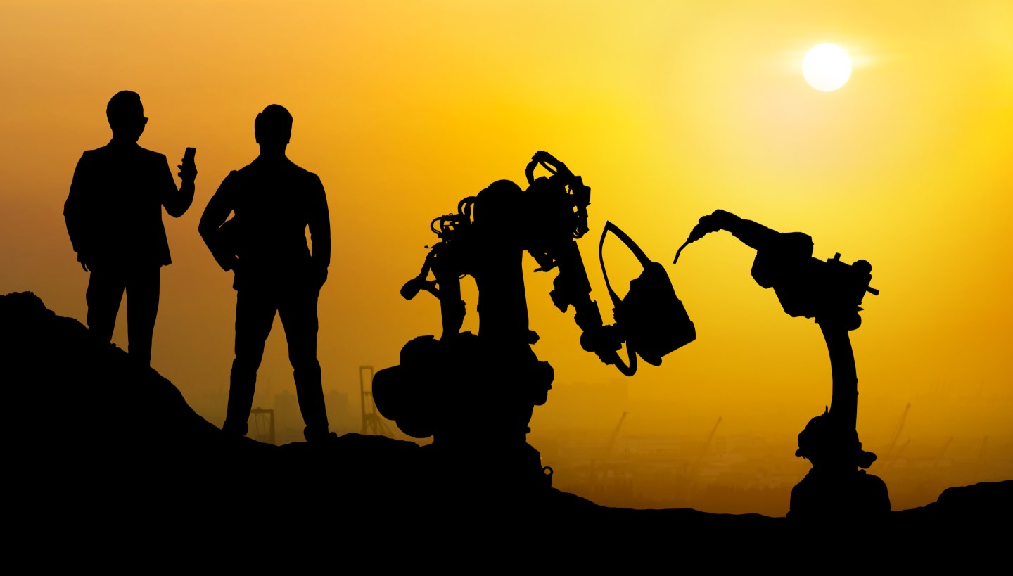 Silhouette of business man command automation robot arm machine technology , industry 5.0 , artificial intelligence trend concept. Sunrise twilight background. 
JIRAROJ PRADITCHAROENKUL—Getty Images