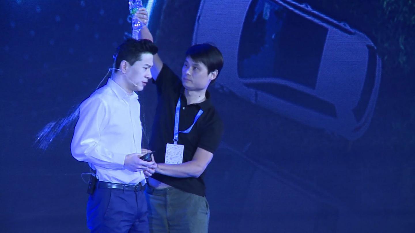 man pours water on Baidu CEO Robin Li