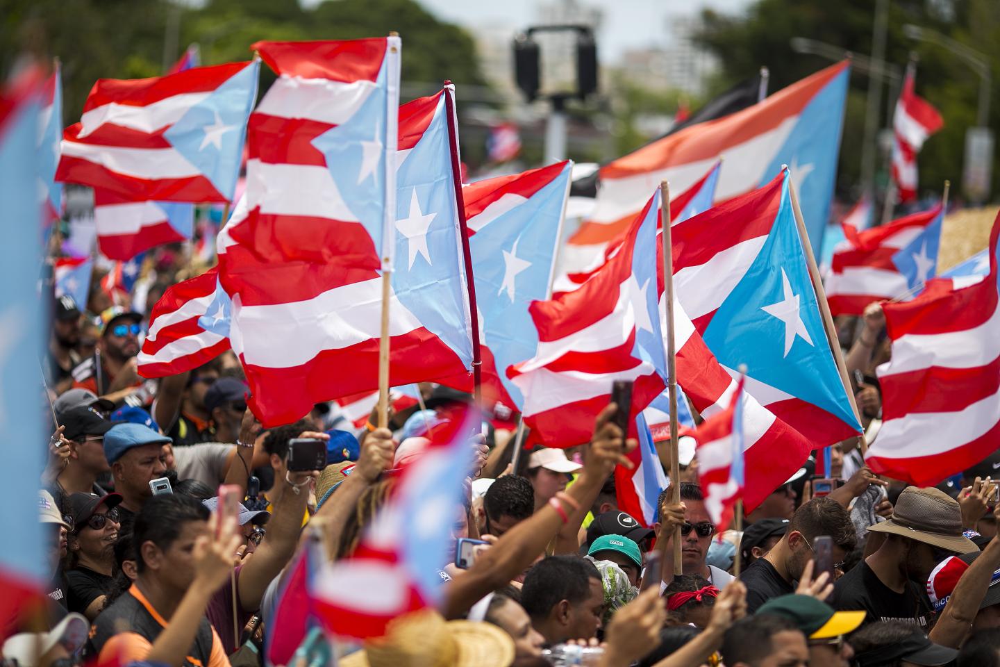 Protestors waving Puerto Rican flags