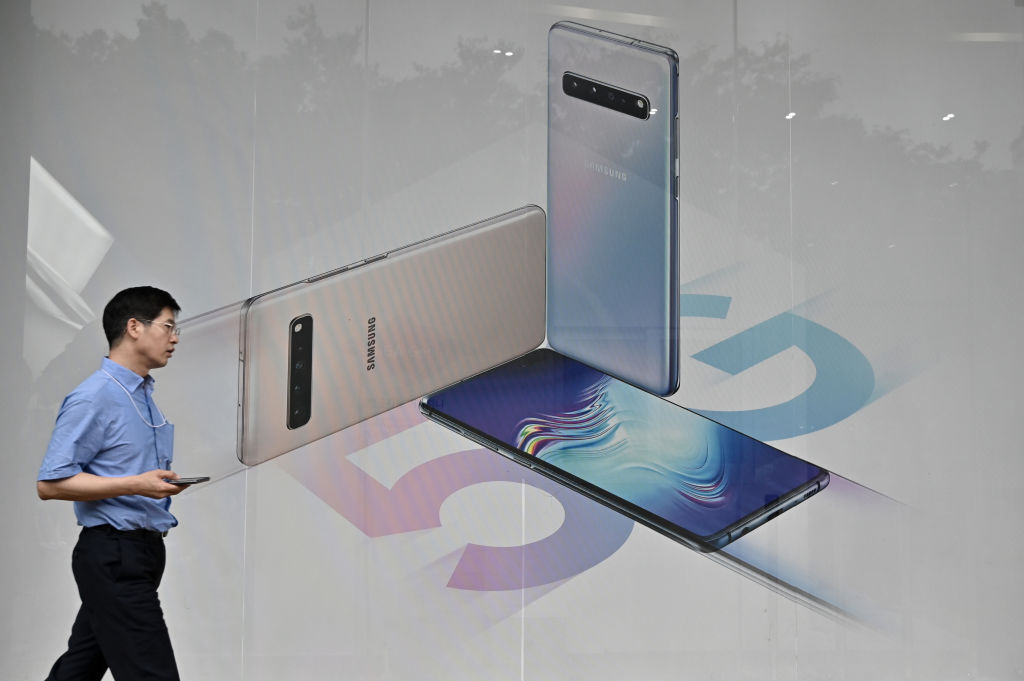A man walks past an advertisement for the Samsung Galaxy S10 5G smartphone in Seoul on July 31, 2019