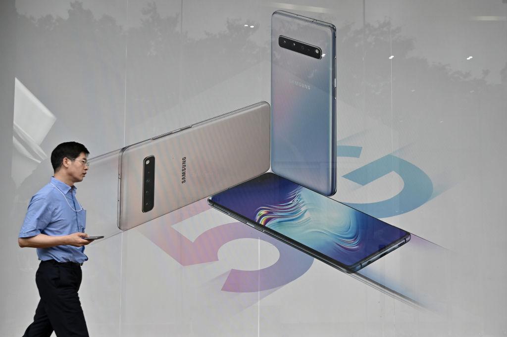 A man walks past an advertisement for the Samsung Galaxy S10 5G smartphone in Seoul on July 31, 2019