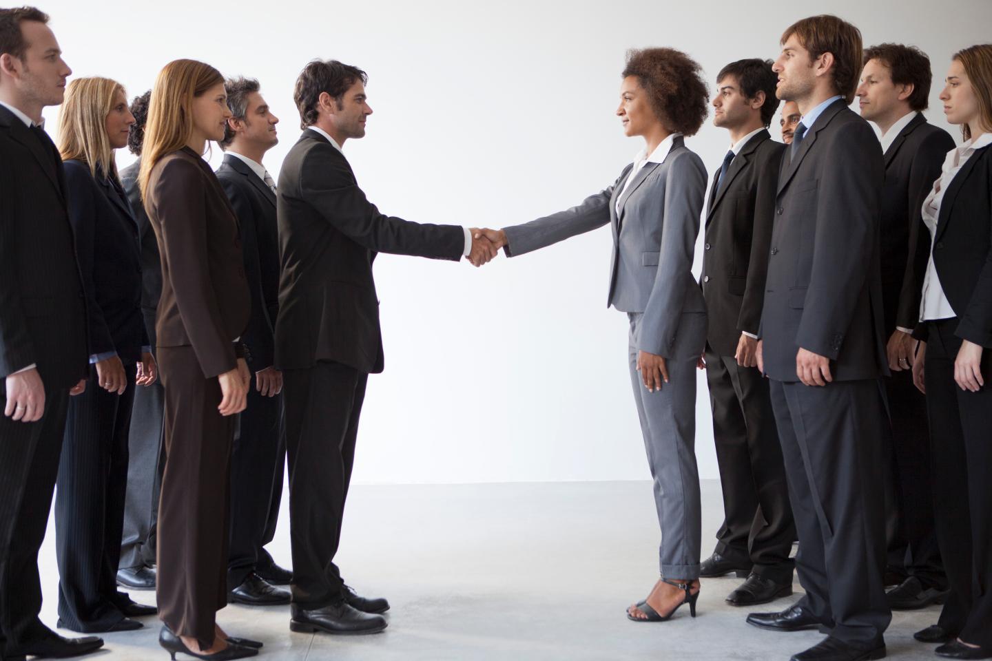 two groups of people shake hands