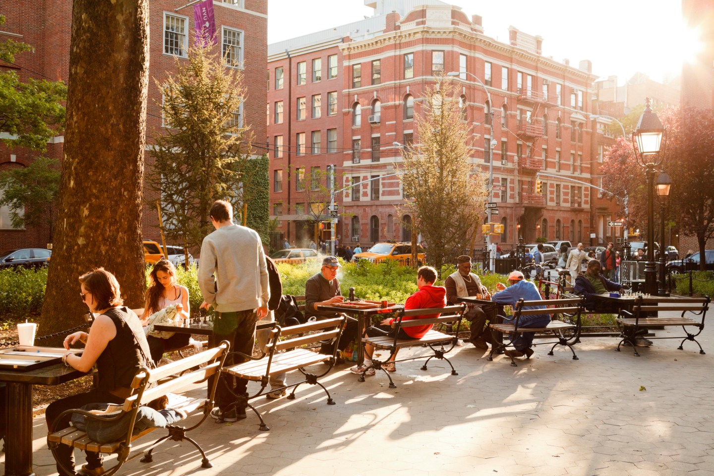 Chess players can be seen in the late afternoon sun in Washington Square Park in Greenwich Village, Manhattan, N.Y.