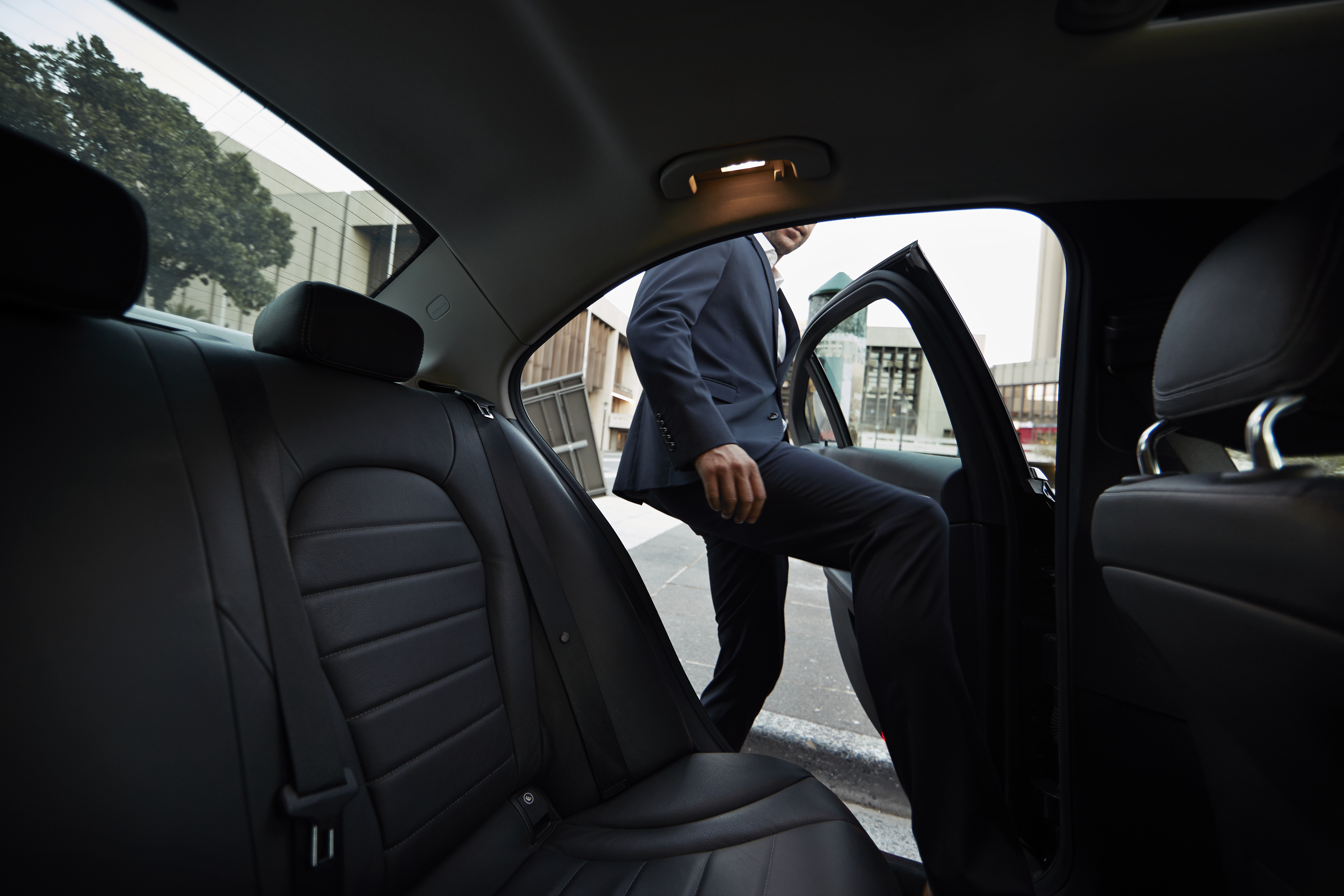 Man getting into a rideshare car