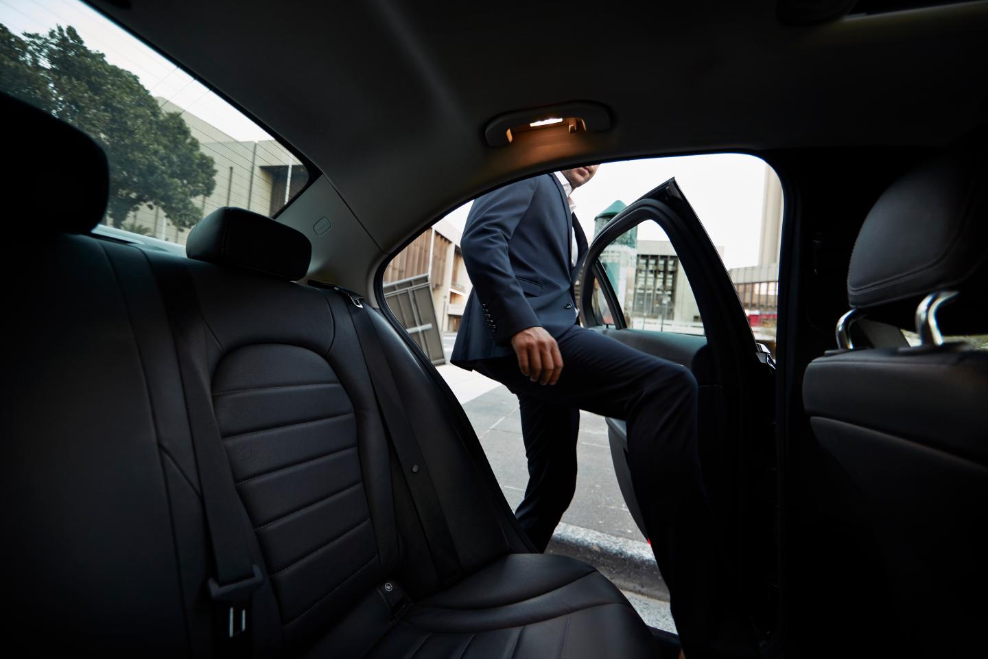 Man getting into a rideshare car