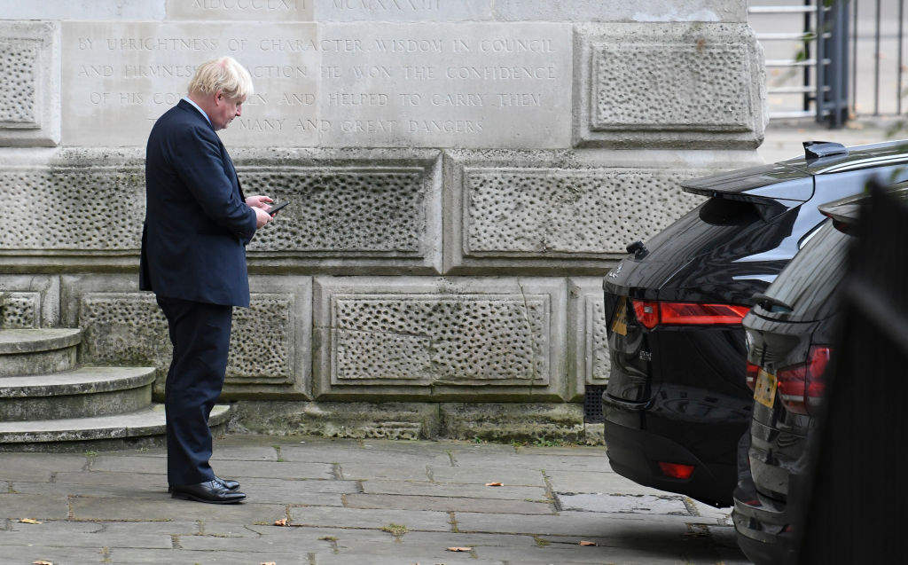 Boris Johnson, a contender to become the next British prime minister, checks his mobile phone outside Downing Street in 2017.