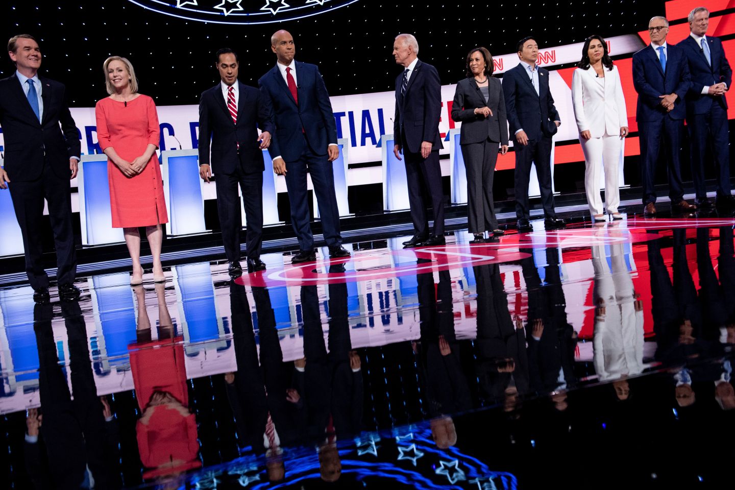 Democratic presidential hopefuls (L-R) US Senator from Colorado Michael Bennet, US Senator from New York Kirsten Gillibrand, former US Secretary of Housing and Urban Development Julian Castro, US Senator from New Jersey Cory Booker, former Vice President Joe Biden, US Senator from California Kamala Harris, US entrepreneur Andrew Yang, US Representative for Hawaii's 2nd congressional district Tulsi Gabbard, Governor of Washington Jay Inslee and Mayor of New York City Bill de Blasio arrive on stage ahead of the second round of the second Democratic primary debate of the 2020 presidential campaign season hosted by CNN at the Fox Theatre in Detroit, Michigan on July 31, 2019. (Photo by Brendan Smialowski / AFP) (Photo credit should read BRENDAN SMIALOWSKI/AFP/Getty Images)