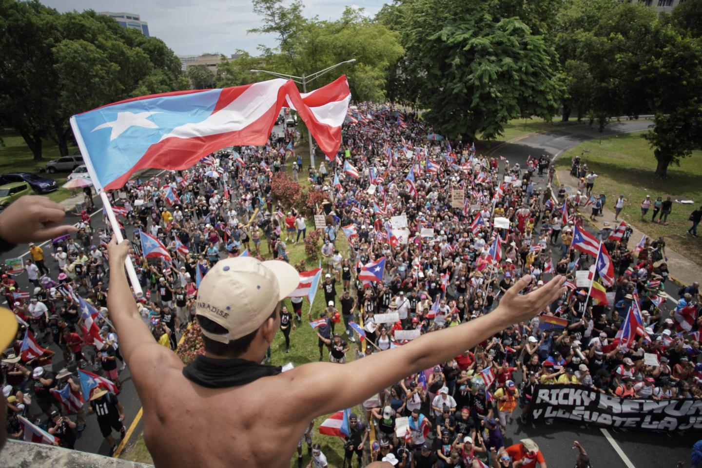 People march in San Juan on July 25, 2019, one day after the resignation of Puerto Rico Governor Ricardo Rossello.