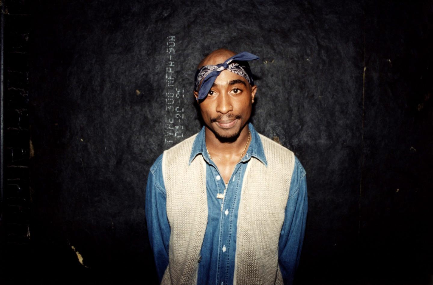 Tupac Shakur poses for photos backstage after his performance at the Regal Theater in Chicago, in March 1994.