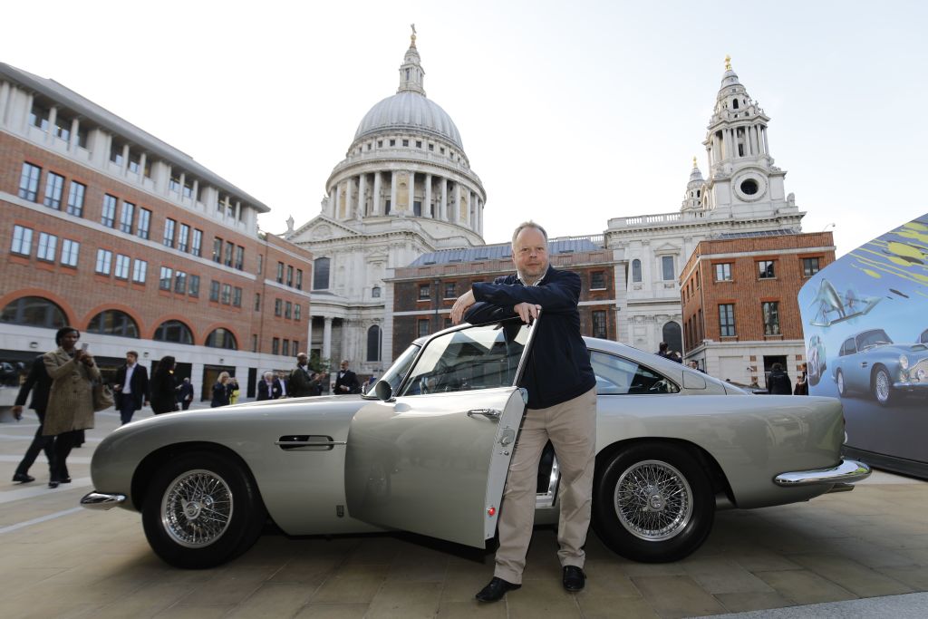 Andy Palmer, CEO of Luxury British sports car manufacturer Aston Martin poses by models of Aston Martin cars as the company is floated on the London Stock Exchange on October 3, 2018 in London.