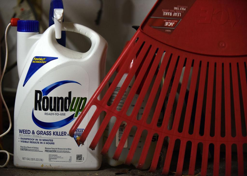 Roundup weedkiller with rake